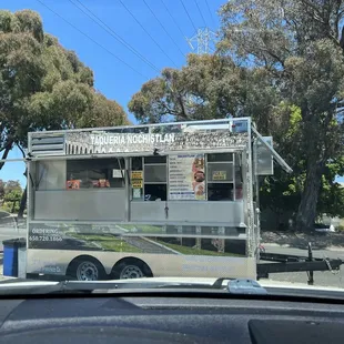 a taqueria truck parked on the side of the road