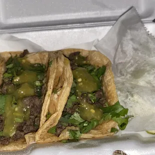 two tacos in a styrofoam container