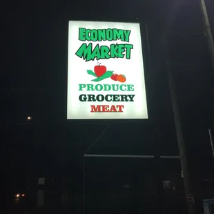 a neon sign for a grocery