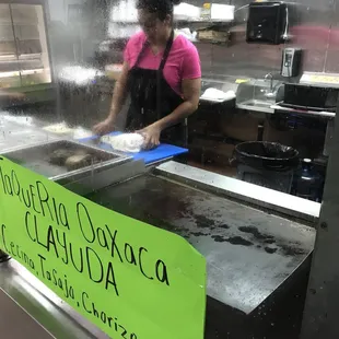 a woman preparing food in a kitchen
