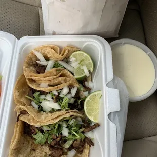 two tacos in a styrofoam container