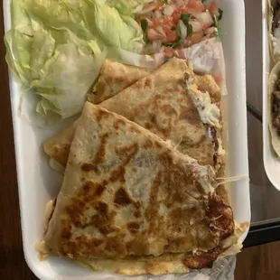 a plate of quesadillas and salad