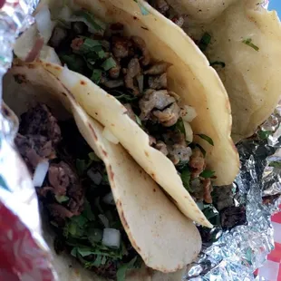Two bistec tacos, one barbacoa.