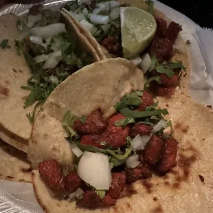 two tacos on a paper plate