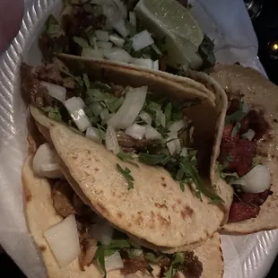three tacos on a paper plate