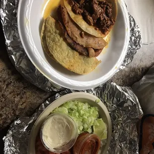a plate of tacos and a bowl of salsa