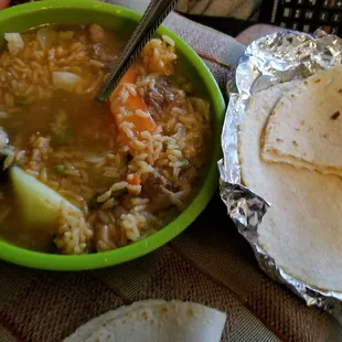 Caldo de res with rice added. Comes with 2 corn tortillas, limes and an order of rice.