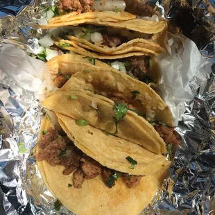 3 beef and 2 chicken tacos with onion and cilantro