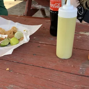 a hot dog and a drink on a picnic table