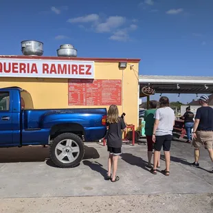 people standing in front of a truck