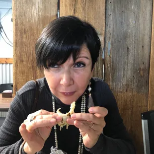 a woman eating a piece of food