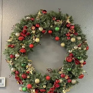  a christmas wreath hanging on a wall