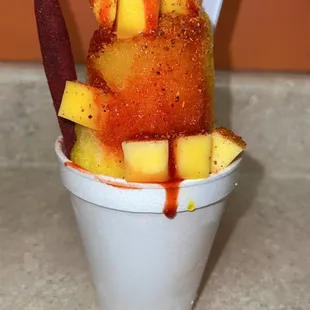 a cup of ice cream with a spoon sticking out of it