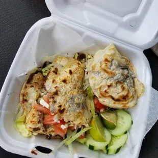 two quesadillas in a styrofoam container