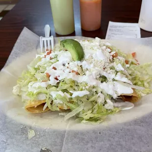 Chicken flautas (taquitos) with table sauces.