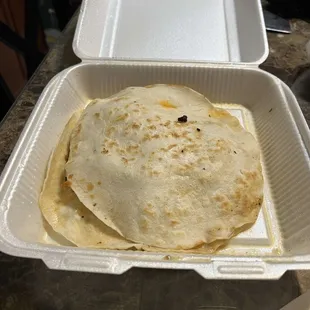 This is 1 of 2 quesadillas we bought. This was the chicken quesadilla with "everything". It was shameful to say the least