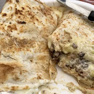 Meaty, cheesy carne asada super quesadilla with pico de gallo, guacamole, sour cream + a grilled, perfectly textured fresh tortilla.