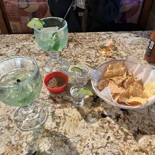 a table with chips and drinks