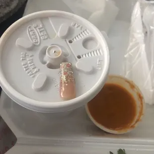 A fake nail in my to go order