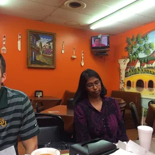 Atmosphere is casual. You can see the wall mural, TV and unfortunately something they need to fix on the ceiling.