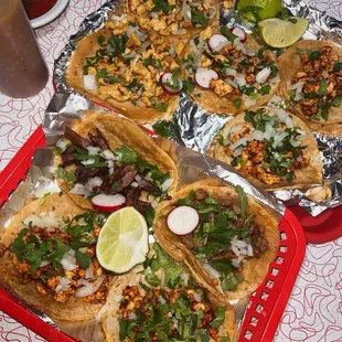 Top tray two on left : pollo Top tray three on right : Pollo Adobado  Bottom tray top left : fried steak Bottom tray top right : steak