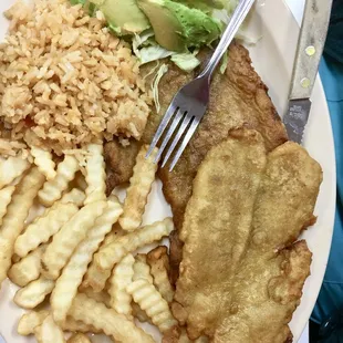 a plate of fish, rice, and vegetables