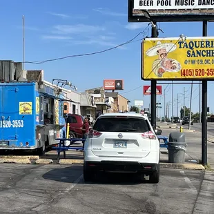 a car parked in front of a food truck