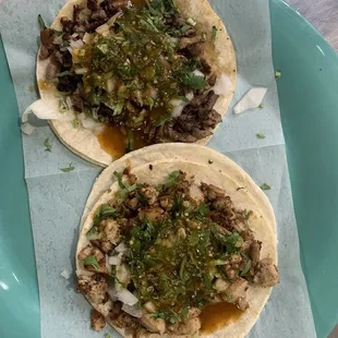 Two soft tacos. The top one is Asada (steak). The bottom is Pollo (chicken).