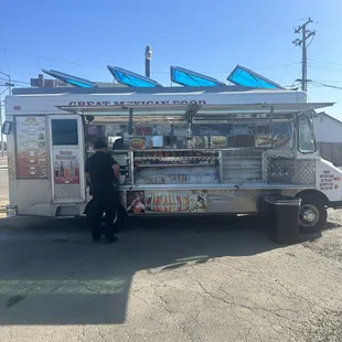 a man standing in front of a food truck
