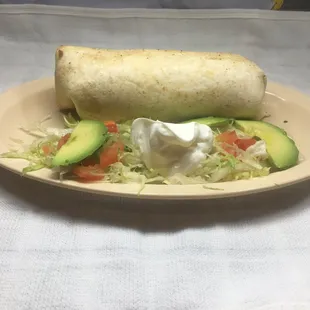 Burrito Made with a flour tortilla, mozzarella  cheese, beans, and your choice of meat, lettuce, tomatoes, avocados and sour cream.