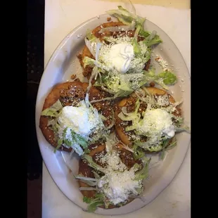 Gorditas Made with fried corn dough, choice of meat, beans, lettuce, sour cream and cheese.