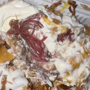 Super nachos with carnitas and no beans or guacamole.