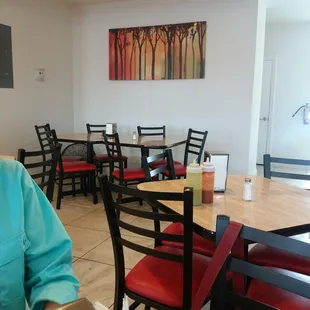 a woman sitting at a table in a restaurant
