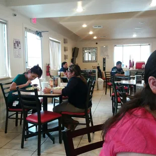 people sitting at tables in a restaurant