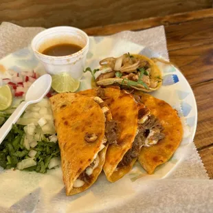 Quesobirria and a chicken taco. Just as the delicious red and green sauce.