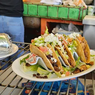 3 crispy tacos for $12 with burrito on the left.