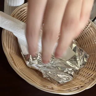a person&apos;s hand holding a piece of tin foil