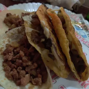 three tacos on a paper plate