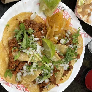 a plate of tacos and a drink