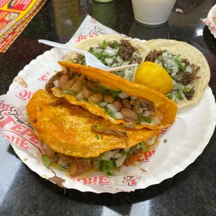 two tacos on a paper plate