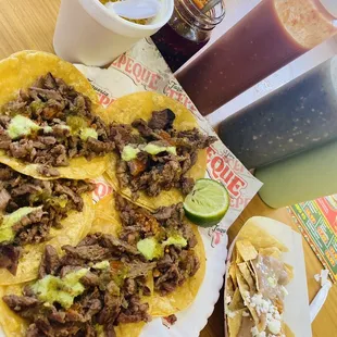 Beef Asada tacos with corn tortillas dipped in oil. Charro beans