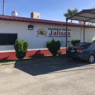 a car parked in front of a restaurant