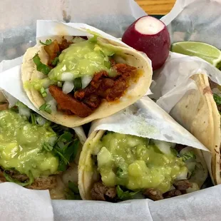 Al pastor on top, lenguas to the right, pollo to the left, and carne asada in the middle.