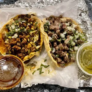 two tacos with meat and vegetables