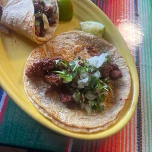a plate of tacos and a lime