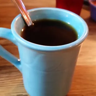 a cup of coffee with a spoon