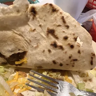 Old tortilla with carne guisada in it