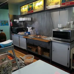 Behind the front counter.