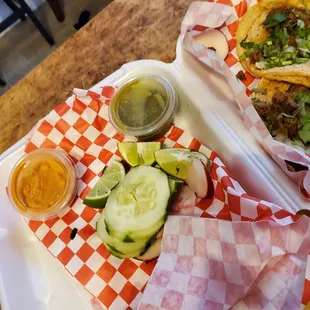 two plates of tacos and a salad