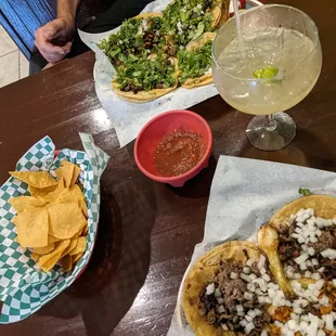  a table of tacos and a salad